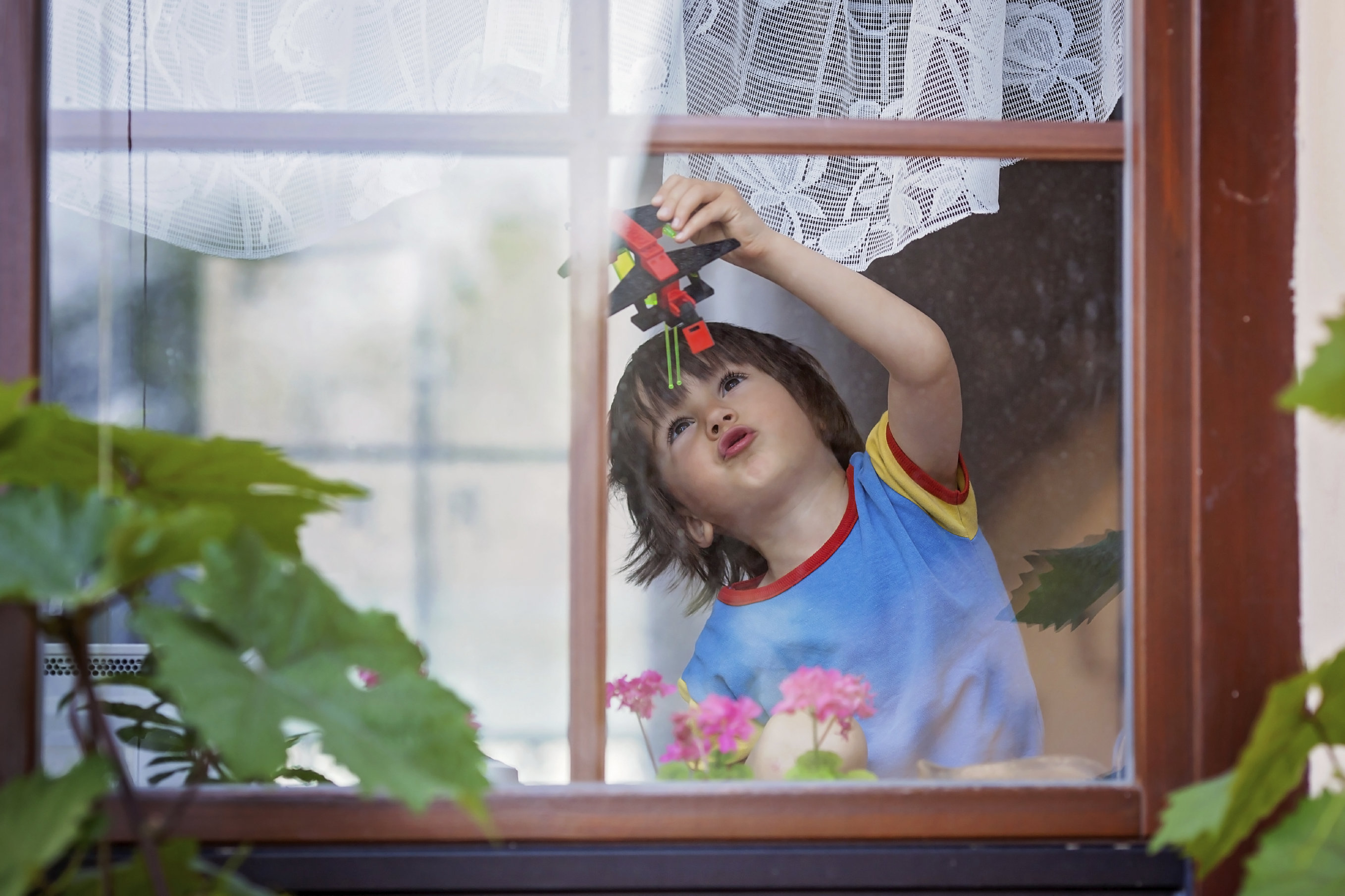 boy playing by window 